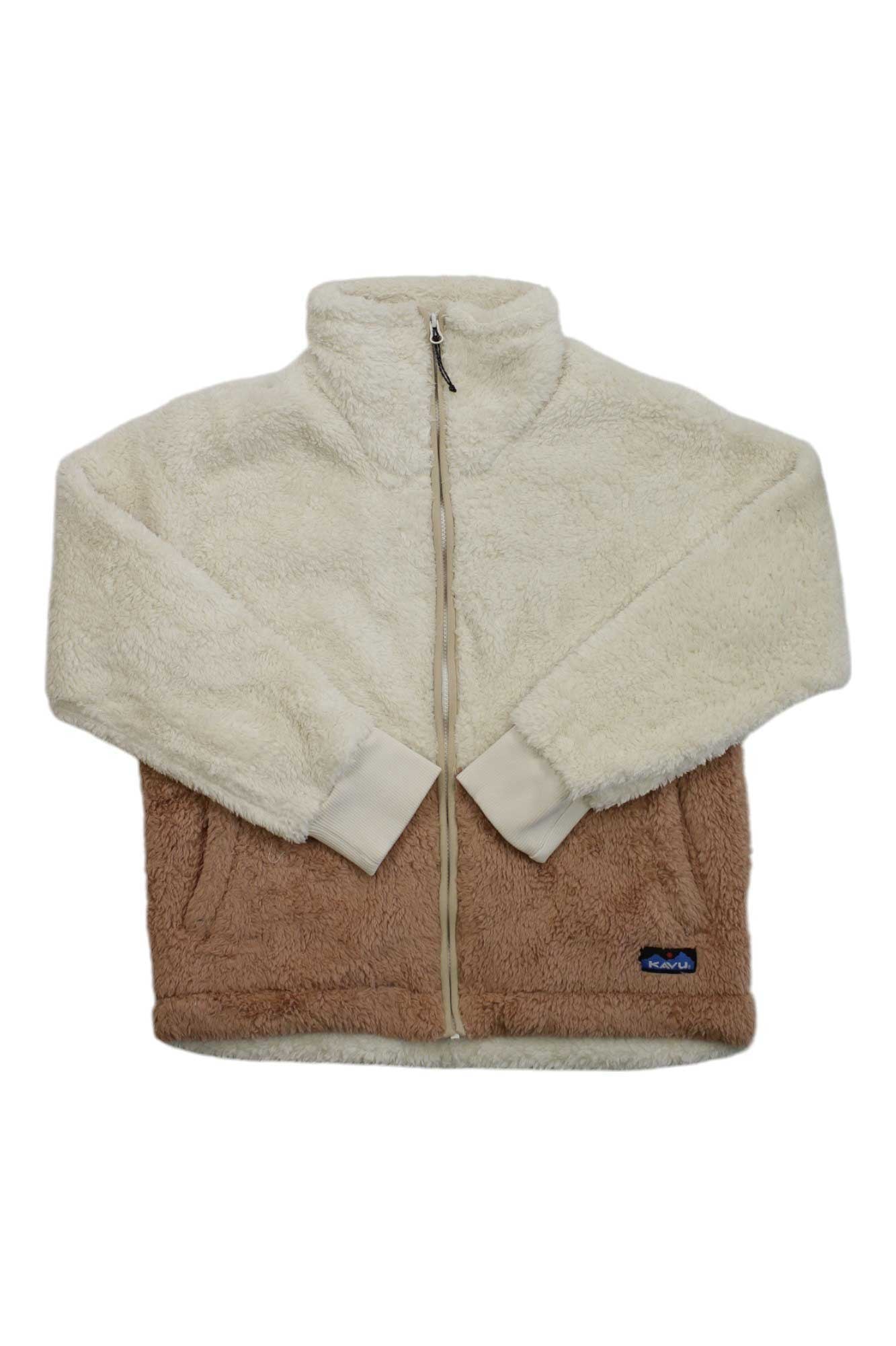 The KAVU Womens Spirit Cove Jacket is a cozy full-zip outdoor piece made from recycled polyester sherpa fleece, featuring a cream top and sleeves, light brown lower half, stand-up collar, front pockets, and a small patch near the hem.