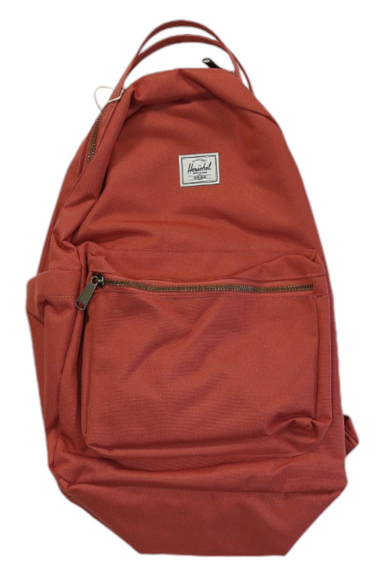 The Herschel Supply Company Nova Backpack is rust-colored, made from recycled fabric, and features a front zip pocket, laptop sleeve, small white brand label, and top handle.