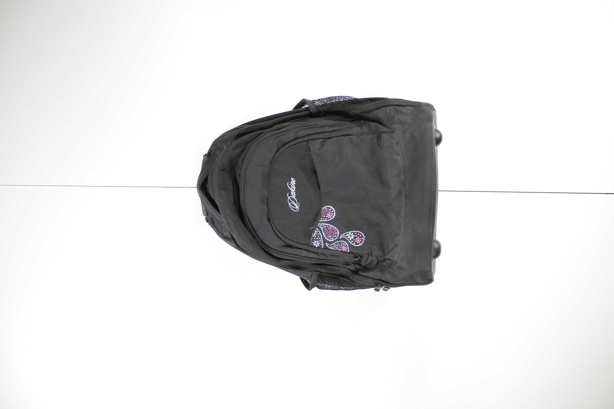 The Womens Wheeled Prom Pack is a black backpack with purple and pink patterns, side mesh pockets, and bottom wheels, making it a stylish choice for carrying outdoor gear.