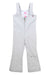 The Girls Snell Stretch Pant features light gray, water-resistant fabric, wide straps, a front zipper, and a slight flare at the bottom. Brand logos appear near the left leg hem and on the inside chest tag.