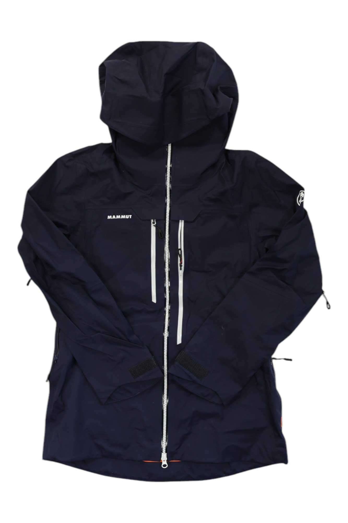 The Mammut Womens Haldigrat Air HS Hooded Jacket is a dark navy, waterproof, breathable alpine skiing jacket with a front zipper, two zippered diagonal chest pockets, long sleeves, and the MAMMUT logo on the chest.