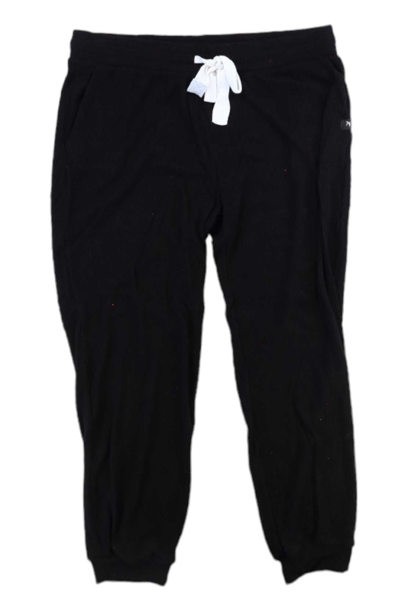 The Glyder Womens Comfort 7/8 Jogger in black features elastic cuffs and a white drawstring, laid flat on a white background—ideal for an effortless athleisure look.