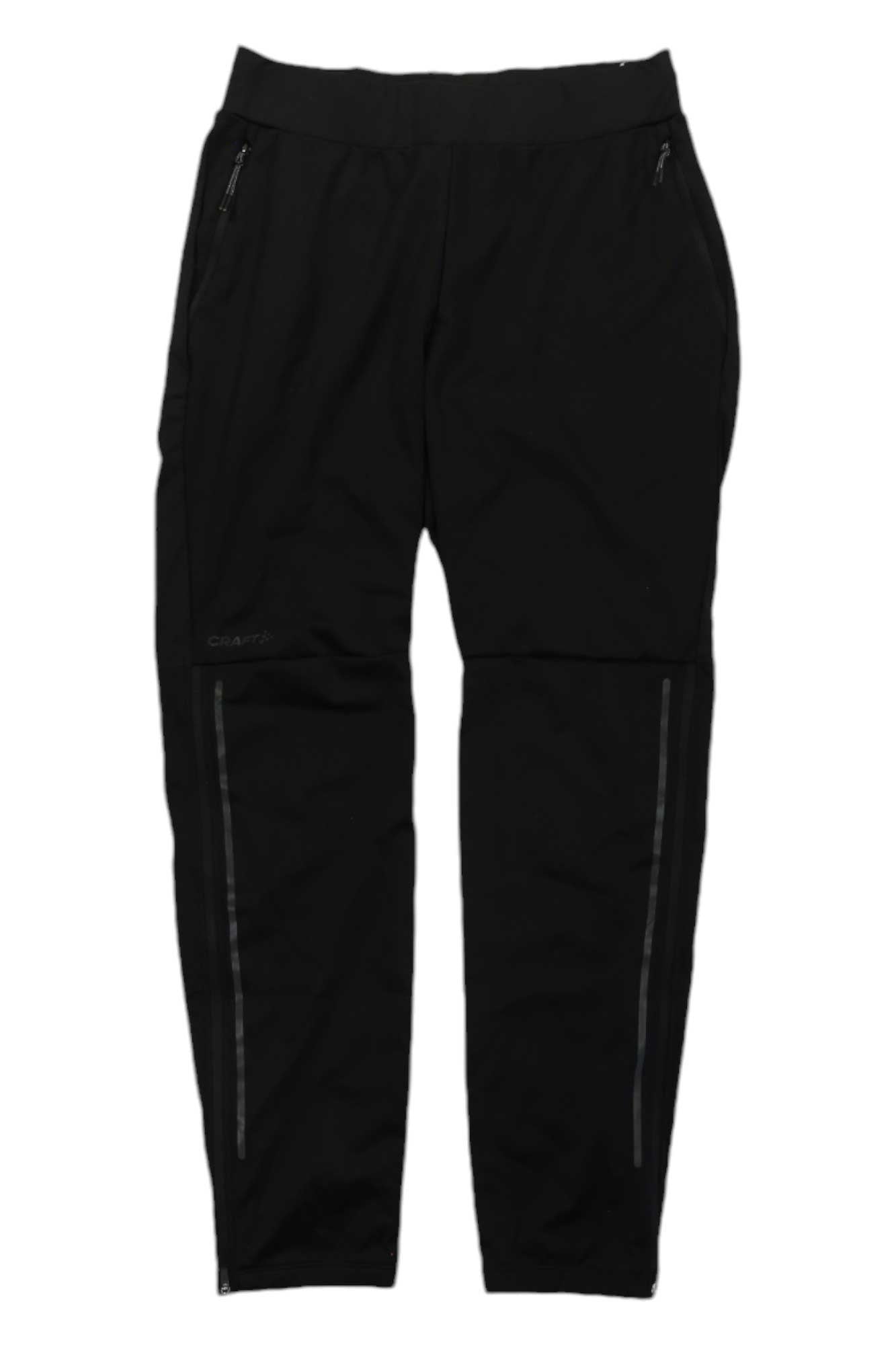 The Craft Sportswear Womens ADV Essence Wind Pant in black features zippered side pockets and horizontal knee zippers. These moisture-wicking hiking pants are shown on a white background.
