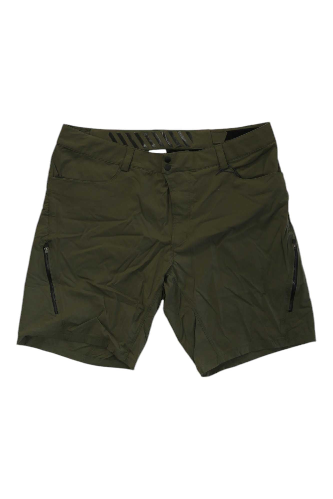 The Showers Pass Men's Gravel Short in olive green features knee-length, water-resistant fabric, button and zipper closure, side zipper pockets, and belt loops, shown laid flat on a white background.