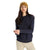 A woman with long brown hair and a neutral expression stands against a plain white background wearing the Icebreaker Womens Central II LS Sweatshirt in dark navy, a mustard yellow knit beanie, and beige pants.