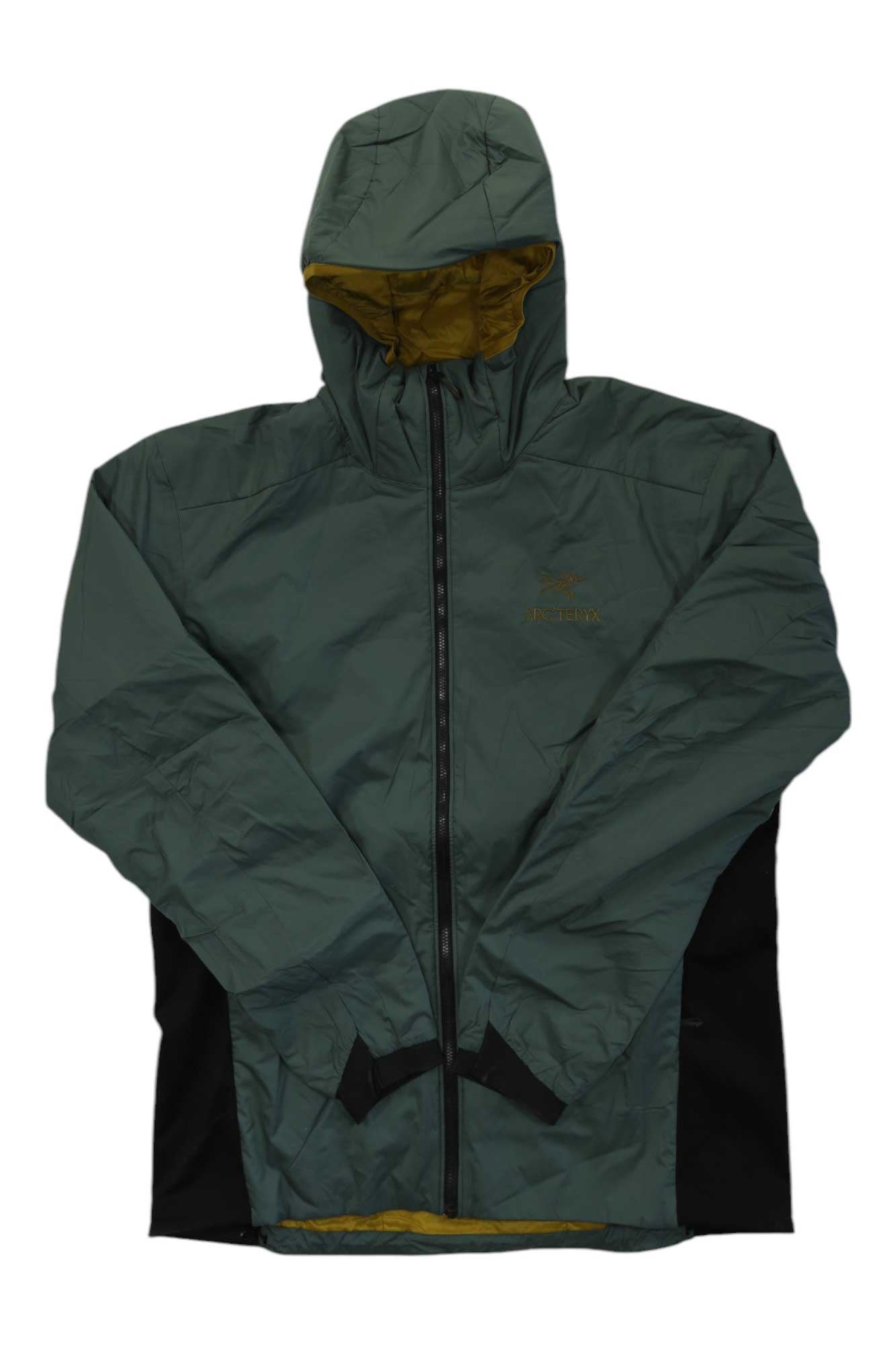 The Arc'teryx Men's Atom Hoody is a green insulated jacket with black side panels and a yellow lining, shown zipped up and laid flat on a white background. This Arc'teryx hoody features Coreloft Compact insulation, making it an ideal midlayer for warmth.