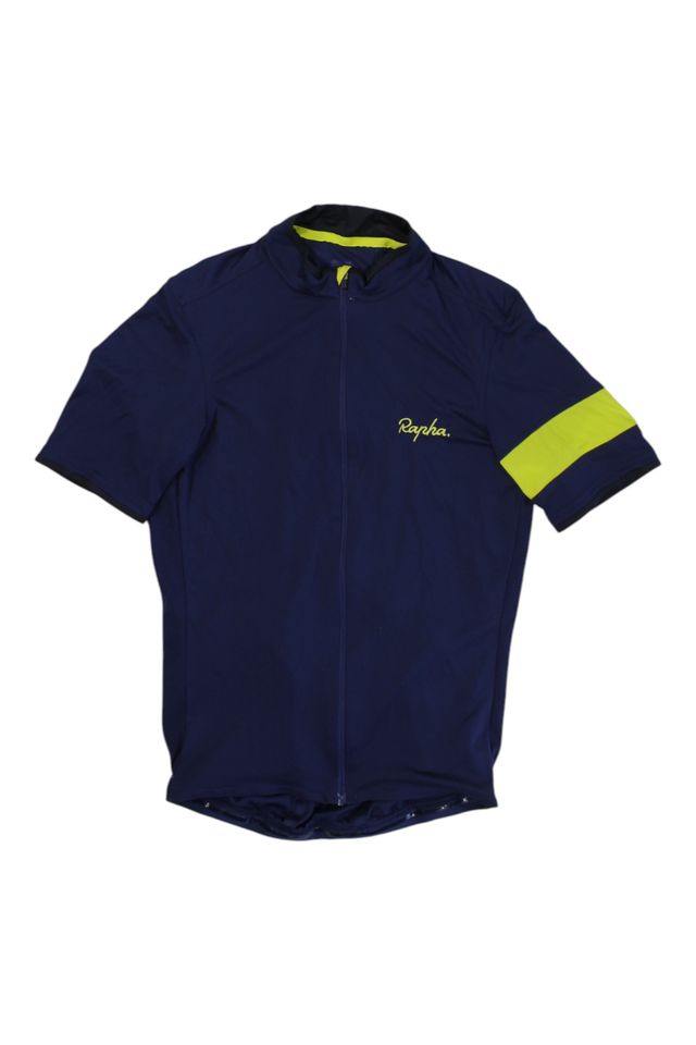 The Rapha Men's Super Lightweight Jersey is a navy blue short-sleeve cycling jersey with a chest logo, front zipper, yellow stripe on the left sleeve, and yellow fabric lining the inside collar.