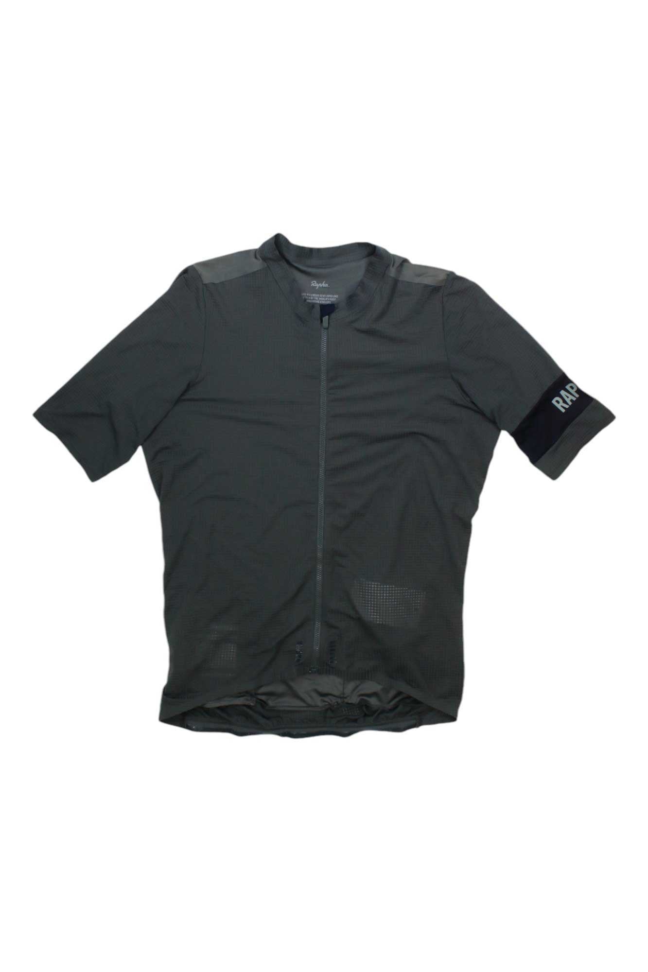 The Rapha Mens Pro Team Flyweight Jersey is a lightweight, short-sleeved cycling jersey in dark gray with a full front zipper, mesh panels for breathability, rear pockets, and a subtle RAPHA sleeve logo—ideal for aerodynamic performance.