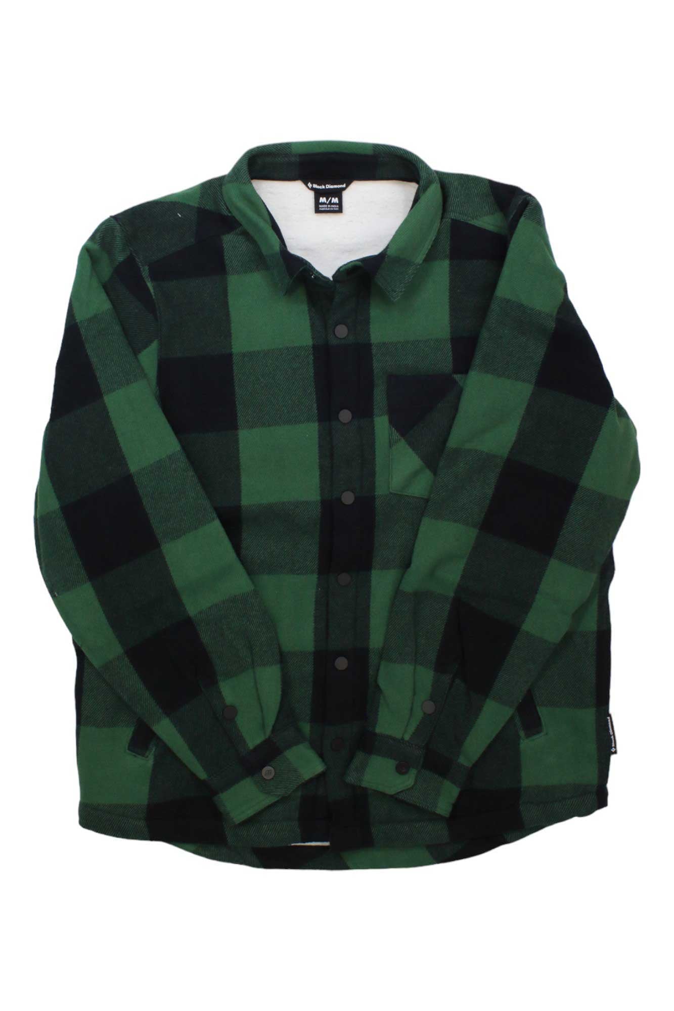 The Black Diamond Mens Project Lined Flannel Shirt features green and black plaid organic cotton, long sleeves, a collar, front buttons, and a chest pocket, shown laid flat on a white background.