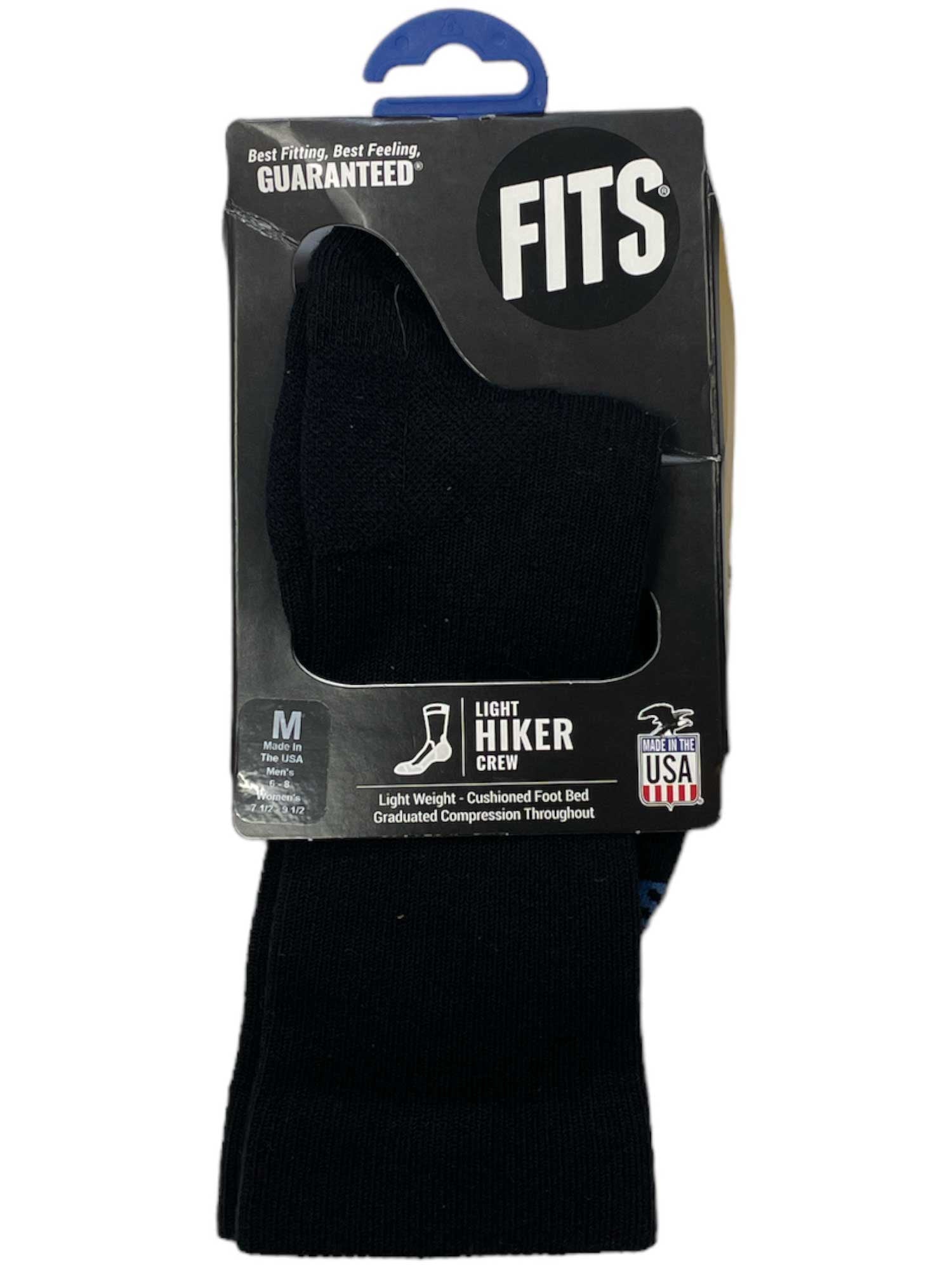 A package of FITS Light Hiker Crew Socks in black, size medium, featuring cushioning, lightweight merino wool, graduated compression, and a Made in USA label on the packaging.