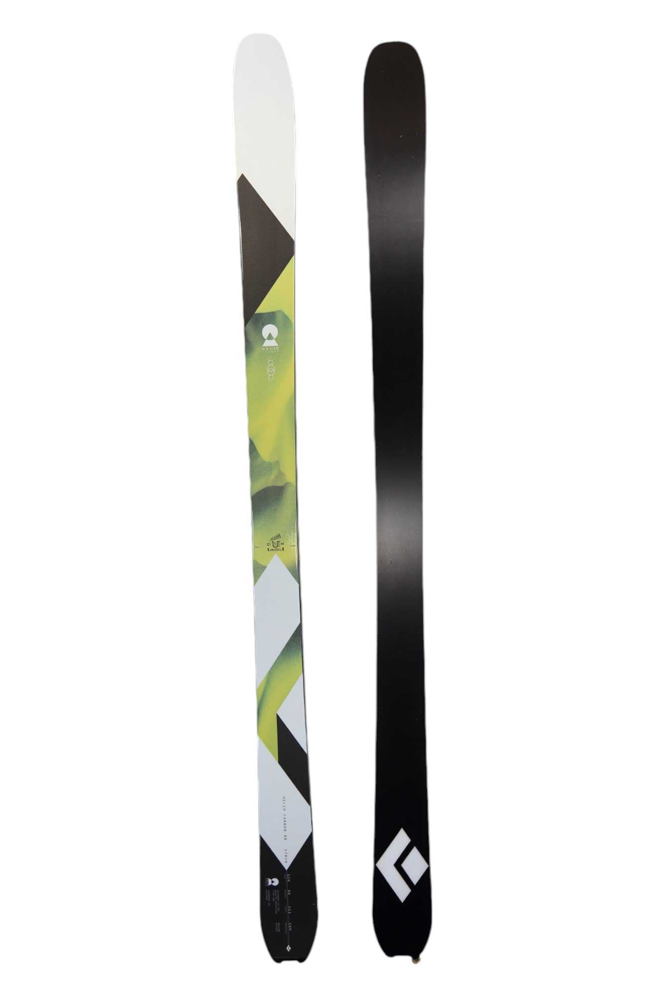 The Black Diamond Helio Carbon 88 Ski is shown: one ski has a white, green, and black geometric design with the Helio Carbon 88 logo; the other features a plain black carbon fiber base with a white logo near the tip—great for backcountry skiing.
