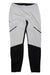 The Craft Sportswear Men's Glide Wind Tight features an elastic waistband, white design with black color blocking on the lower legs and angled thigh accents, all crafted from recycled sportswear material for eco-conscious comfort.