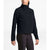 Wearing The North Face Womens Shelbe Raschel Pullover, a black fleece jacket featuring a high collar and side pockets, a person stands against a plain white background with head turned slightly to the side.