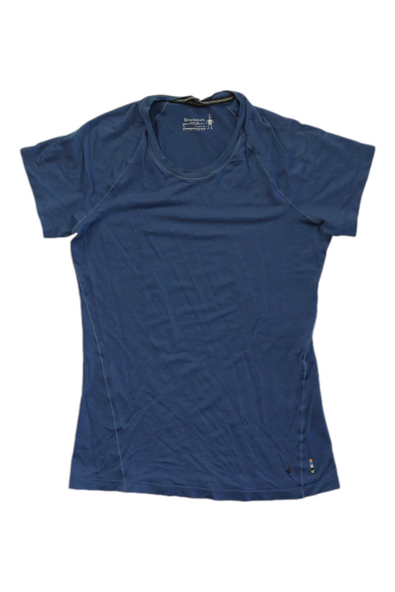 The Smartwool Mens Merino Sport 150 Tee is a blue, short-sleeved running shirt for men with a round neck, made from breathable merino wool and offering UPF 20+ sun protection. Laid flat against a white background, it shows slight wrinkles.