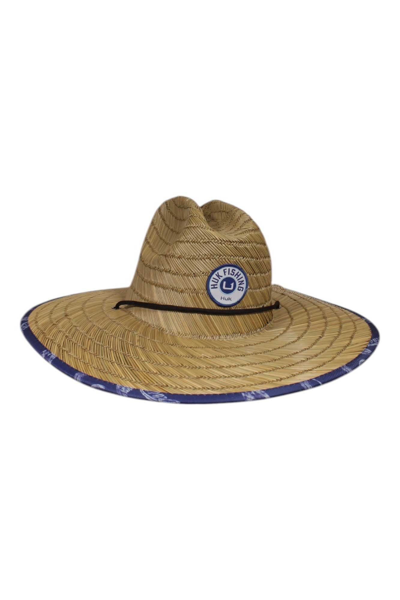 The Huk Mens Straw Palm Wash Hat is a wide-brimmed outdoor hat with a blue and white Salt Life patch on the front and blue patterned trim around the brim, providing excellent sun protection.