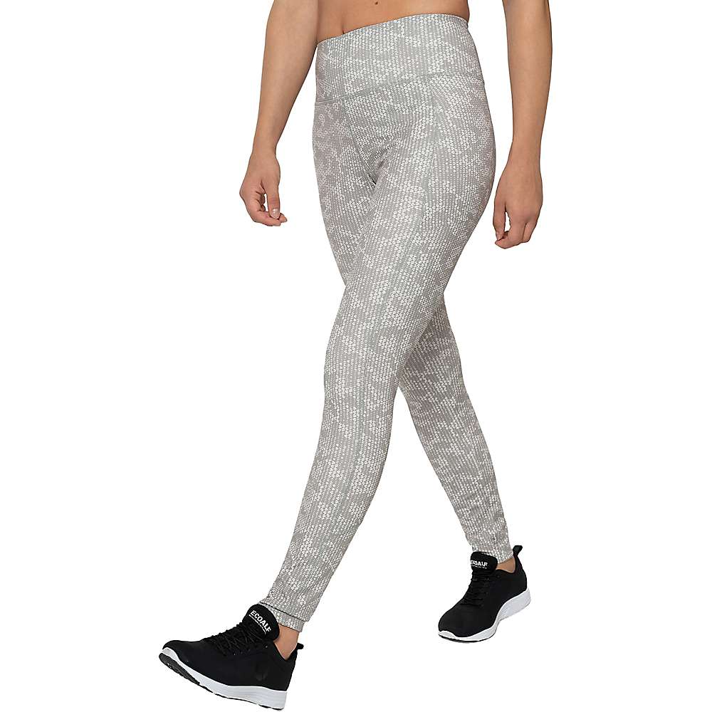 A person shown from the shoulders down walks forward in GoLite Womens ReBound Leggings, featuring a light gray and white pattern, paired with black athletic shoes against a white background.