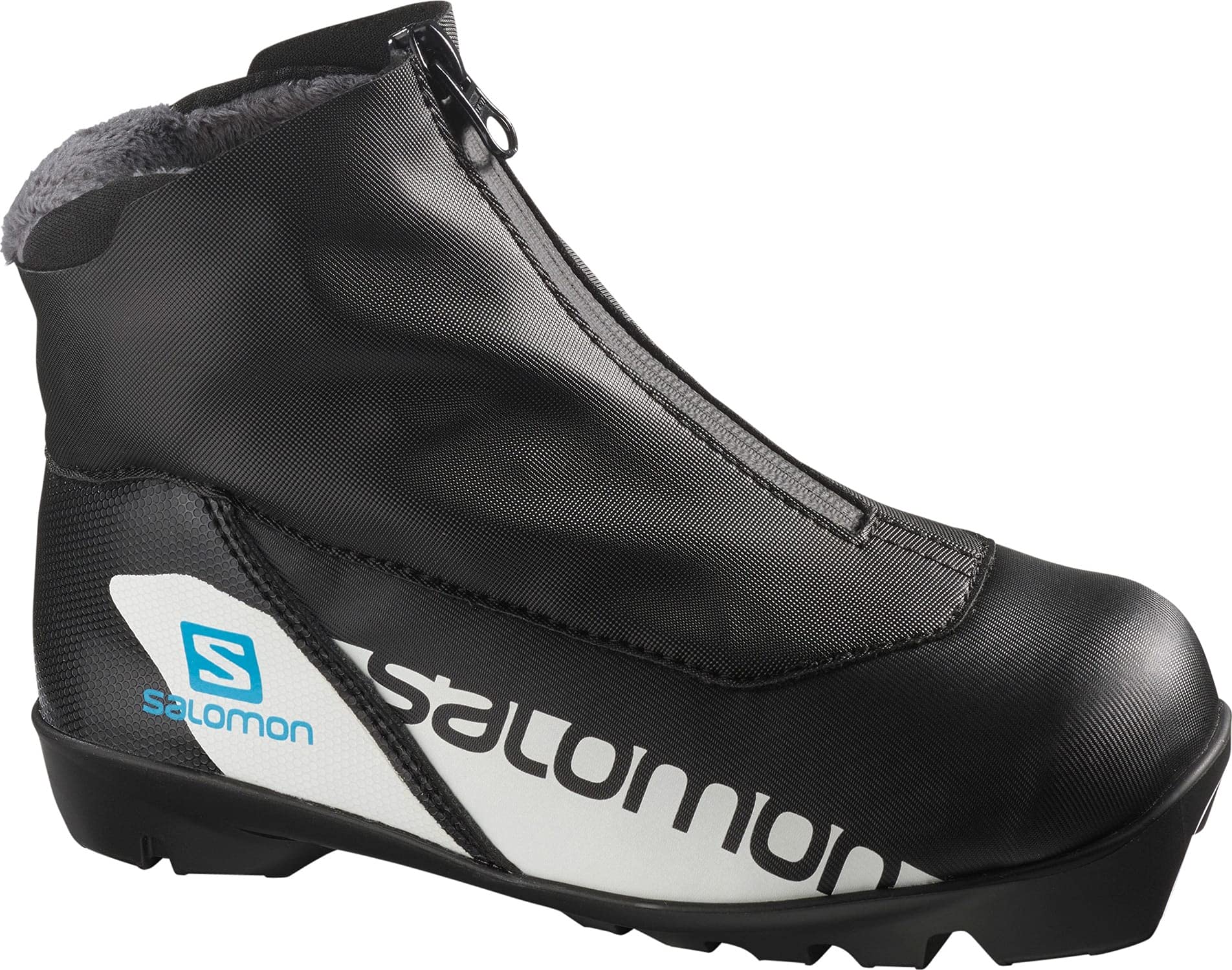 The Salomon RC Prolink Junior Kids XC Ski Boots are black with a zippered cover, white Salomon logo side panel, textured sole, and gray fleece lining at the top.
