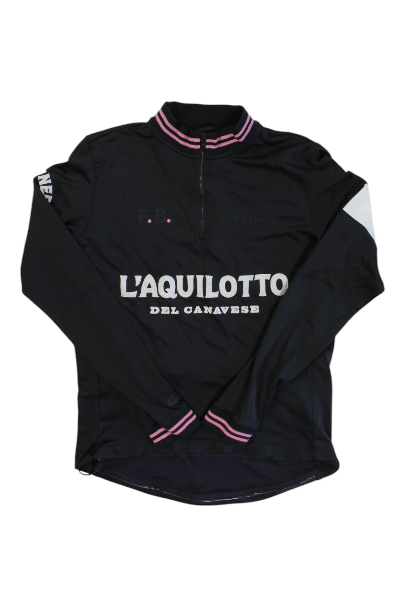 The Rapha Balmamion Club Jersey is a long-sleeve black cycling jersey with pink and white striped collar and cuffs, half-zip front, and "LAQUILOTTO DEL CANAVESE" in white text on the chest from our limited edition collection.