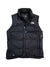 The Women's Nuptse Vest is a black insulated vest with a front zipper, high collar, The North Face logo on the chest, and "700" stitched near the bottom left to indicate its warm down fill power.