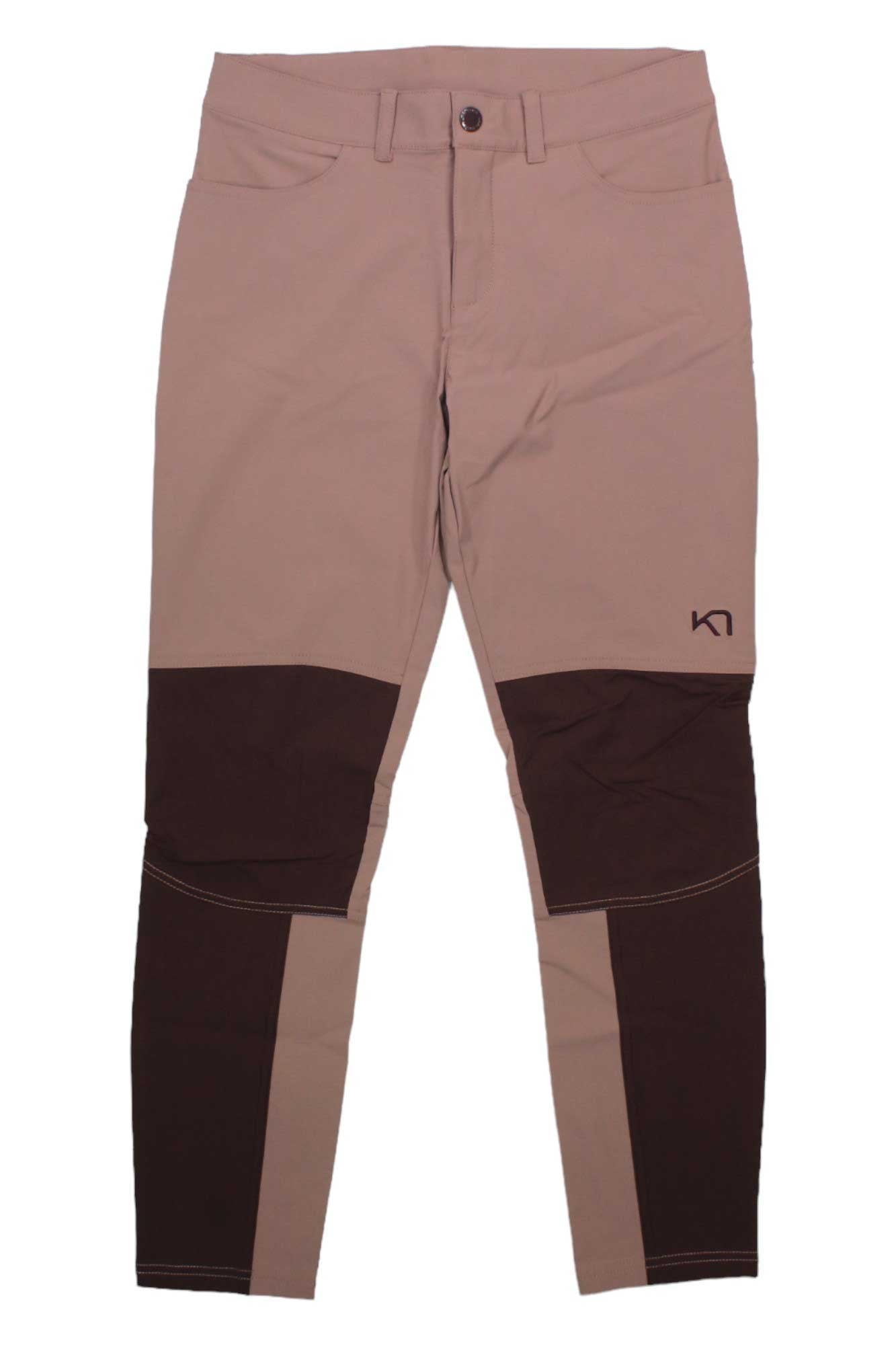 The Kari Traa Womens Thale Hiking Pant features a tan and brown two-tone design, reinforced knees and shins, front pockets, button closure, a small right thigh logo, and eco-friendly materials. Shown laid flat on a white background.