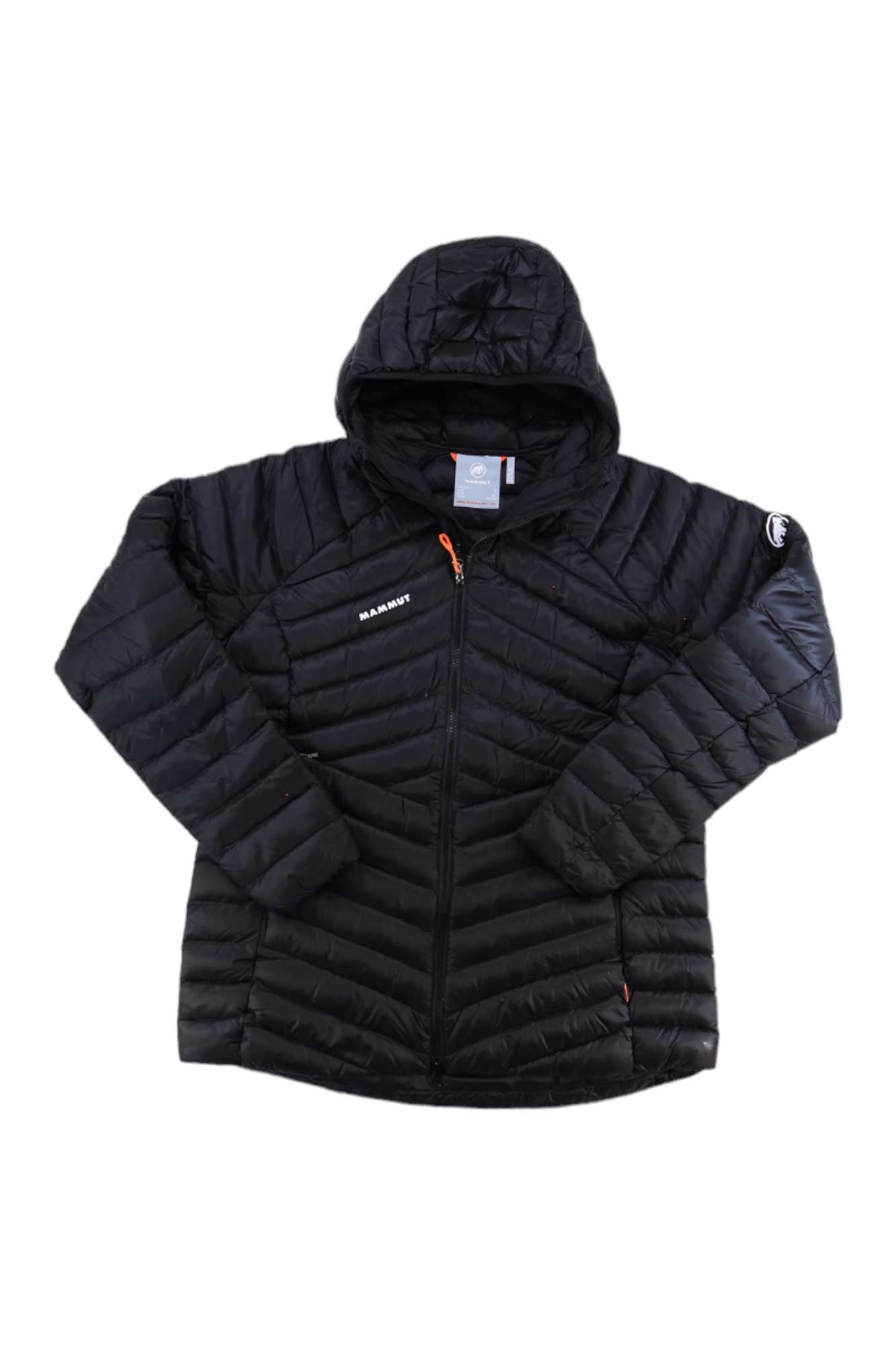 The Mammut Womens Broad Peak IN Hooded Jacket is a black, lightweight down coat with a hood, front zipper, and subtle diagonal quilting. It features the Mammut logo on the chest and a patch on the upper sleeve.