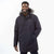 A man smiles with one hand in his pocket, wearing the Moosejaw Men's Hooded Down Parka with a faux fur-lined hood, standing against a plain white background.