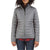 A person wearing the Moosejaw Womens Cozy Down Insulator Jacket in gray with a front zipper, high collar, and horizontal stitching, paired with a red plaid shirt underneath and blue jeans. The jacket is made from recycled polyester.