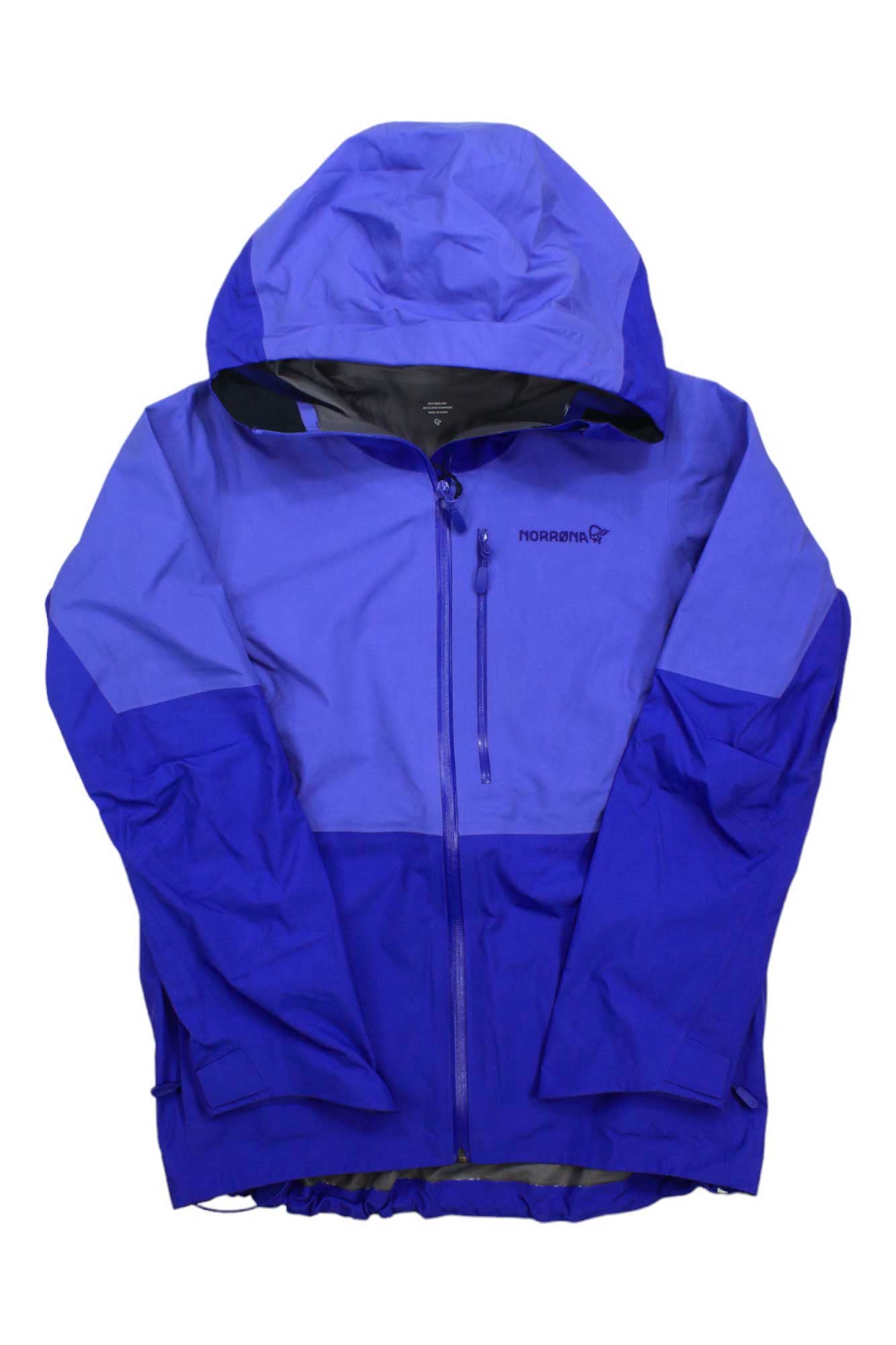 The Norrona Womens Lofoten GTX Jacket is a blue, two-tone GORE-TEX PRO shell with a hood, front zipper, chest pocket, and Norrona logo on the left chest. Designed for mountaineering, it offers long sleeves and reliable outdoor protection.