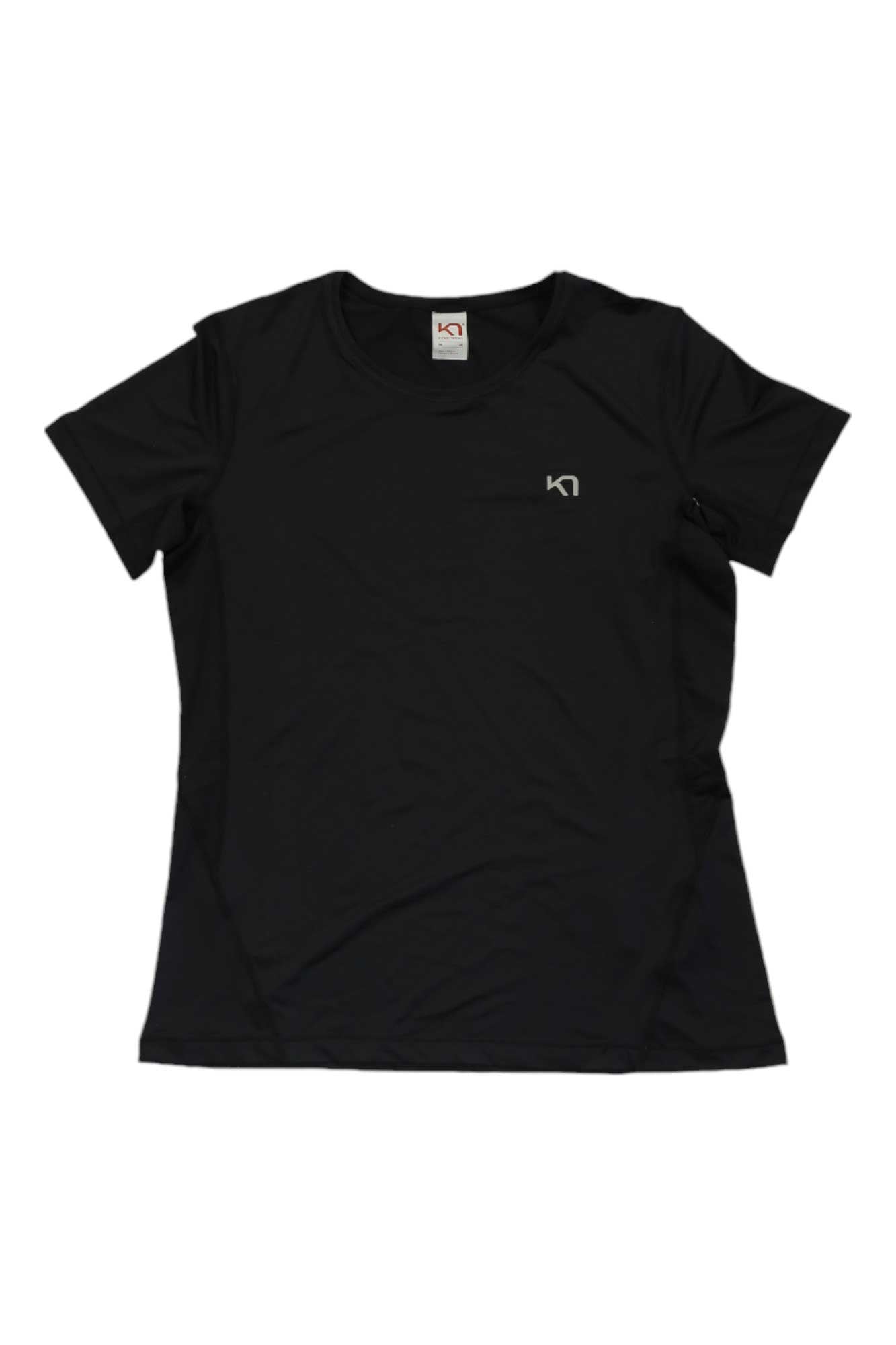 The Kari Traa Womens Nora 2.0 Tee is a quick-drying, eco-friendly black hiking shirt with short sleeves, a crew neckline, and a small white logo on the left chest, shown laid flat on a white background.
