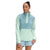 A woman wears the Women's Mountain Sweatshirt Pullover 3.0 in light blue and mint green, featuring a high collar and snap buttons, made from recycled polyester. She pairs it with matching shorts and smiles gently while looking to the side.