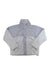 The Under Armour Womens Mission Boucle Swacket is a light gray, water-resistant jacket with a high collar, long sleeves, smooth panels on top and arms, and soft boucle fabric on the lower body and underarms for comfort.