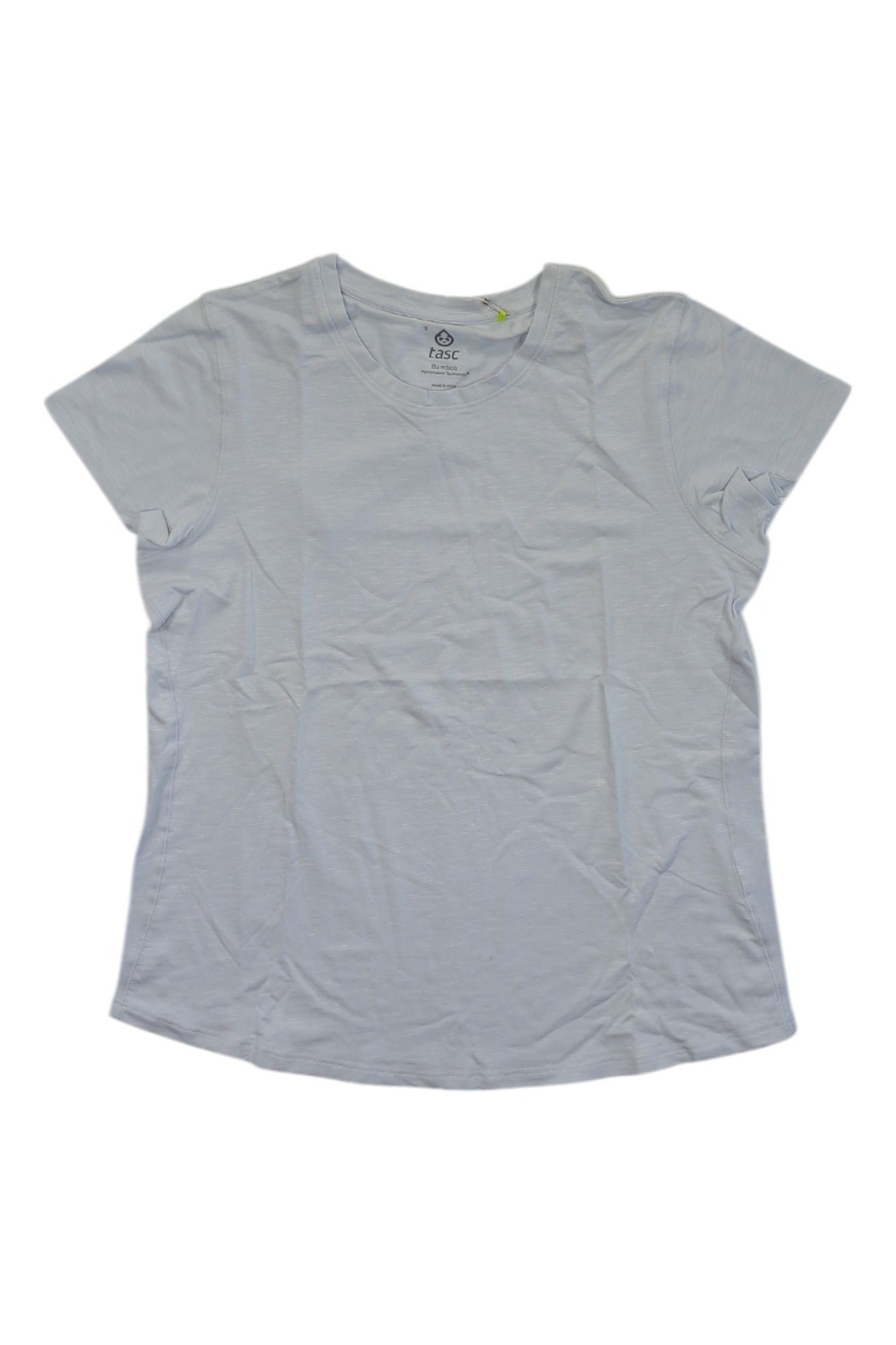 The Tasc Womens NOLA Fitness T is a plain, short-sleeved light blue performance top with a round neckline, laid flat on a white background. Its moisture-wicking fabric ensures comfort for active women.