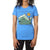 A person wears the Moosejaw Women's Fried Pickle SS Tee, made from recycled polyester and organic cotton, with mountain, yoga pose, and orange sun graphics. The head is cropped out against a white background.