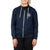 A person in the Moosejaw Women's Salt Water Zip Hoody—navy blue, organic cotton/recycled polyester fleece, white drawstrings, chest patch—and black pants stands against a white background.