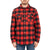 A man wearing the Moosejaw Mens Hot Toddy Heavyweight Flannel with buttoned front and chest pockets, paired with blue jeans, stands with his arms relaxed at his sides.