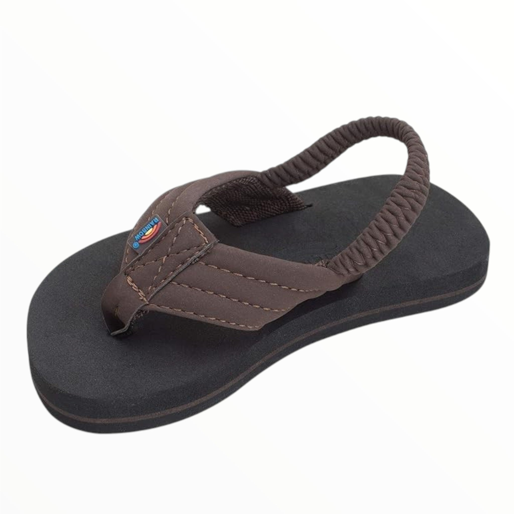 A single Rainbow Kids Grombows Sandal features brown fabric straps, a black sole, visible stitching, a neoprene strap, and a woven elastic heel strap, shown on a white background.