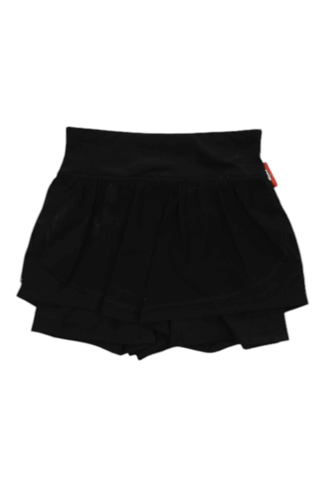 Spanx Women’s The Get Moving Short features a layered black design with a skirt overlay atop fitted, high-waisted shorts. Designed by Spanx, this skort has a wide, stretchy waistband for comfort and a four-way stretch fabric that boosts mobility. A small red tag accents the right side.
