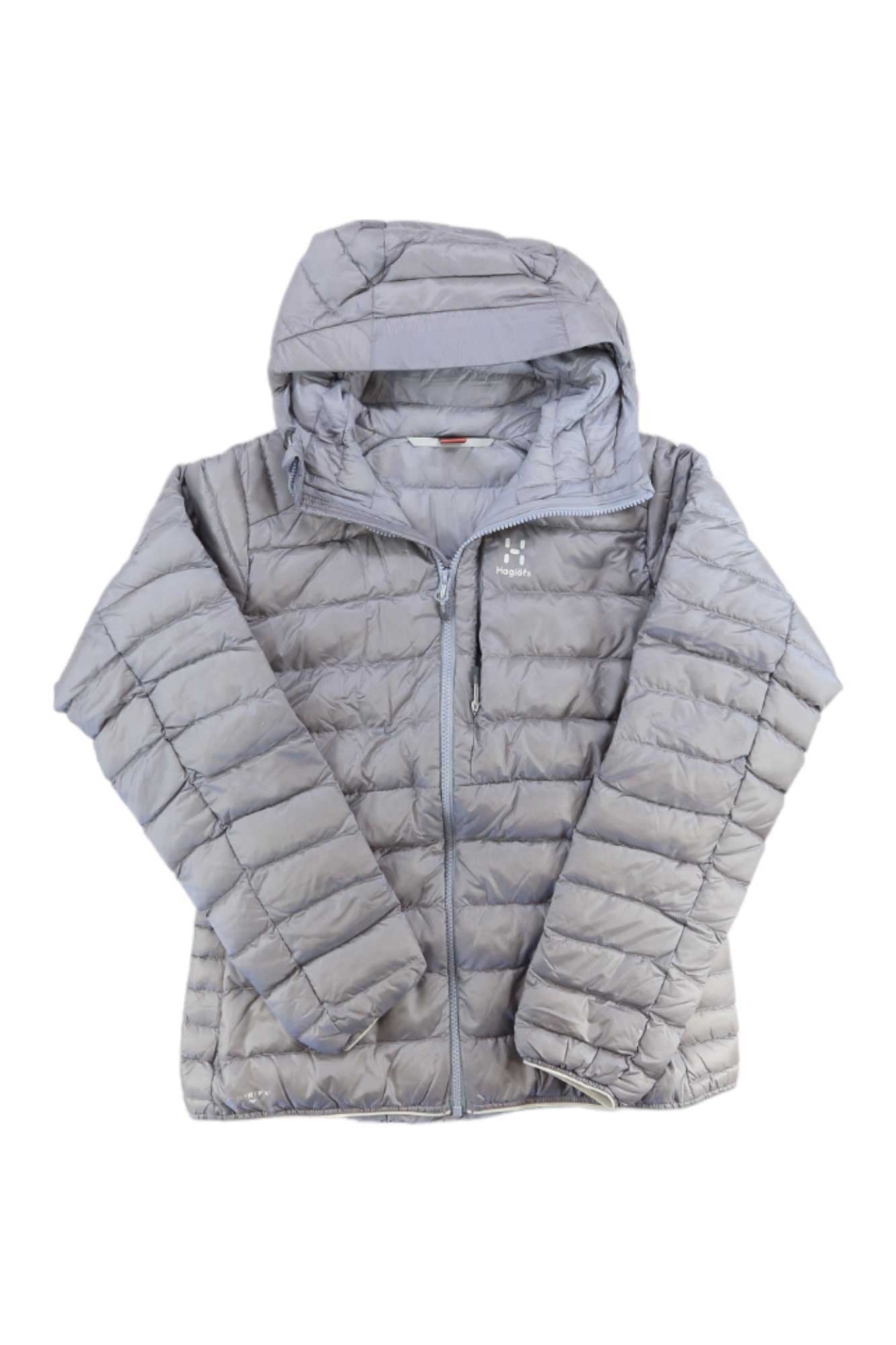 The Haglofs Womens Roc Down Hoodie in light gray features a front zipper, horizontal quilting, side pockets, an attached hood, and a fluorocarbon-free Pertex shell. Shown laid flat on a white background.