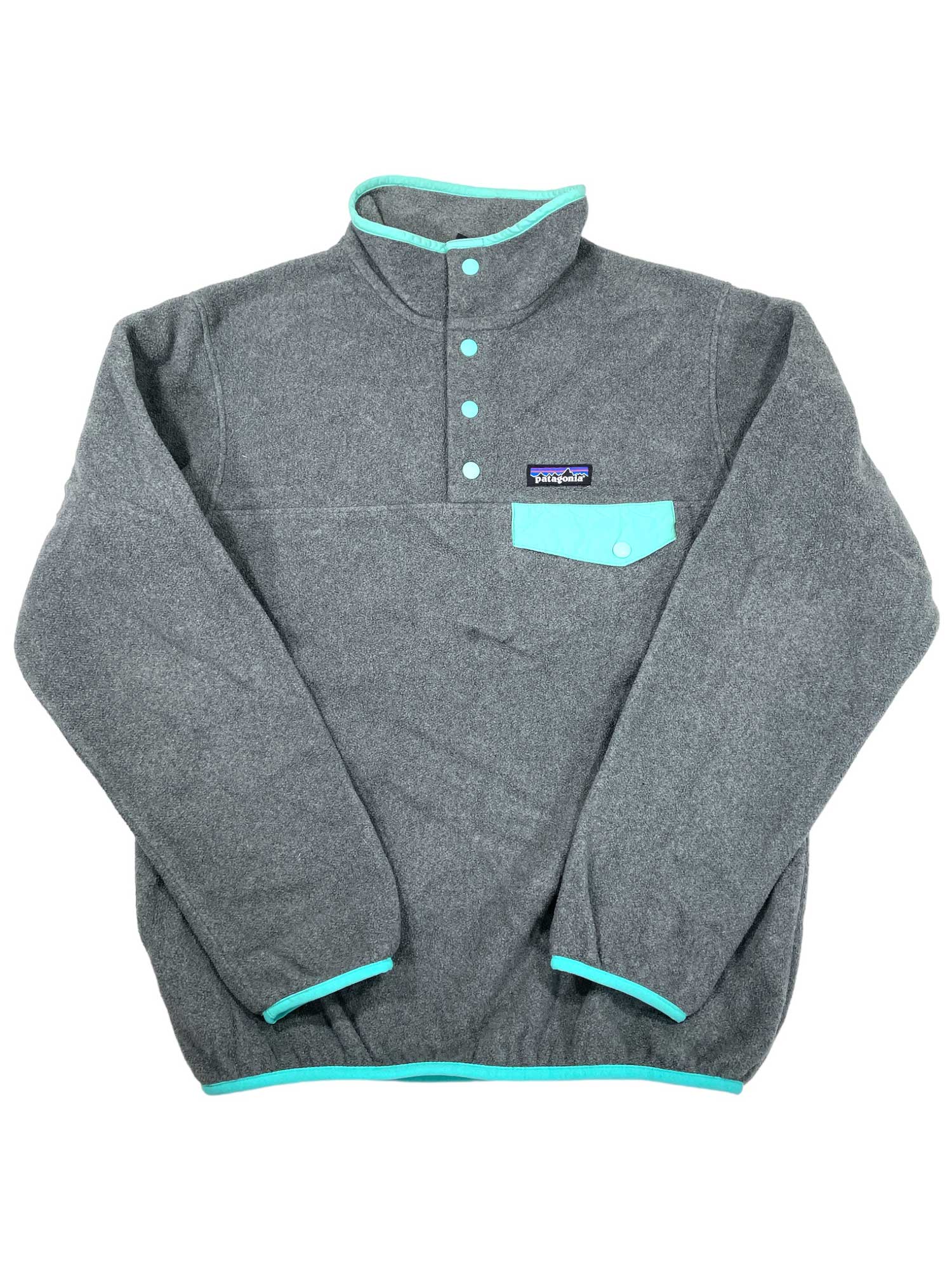 The Women’s Lightweight Synchilla Snap-T Fleece Pullover is a gray polyester fleece with light blue-green trim, high collar, long sleeves, chest pocket, and visible Patagonia logo. Fair Trade Certified.