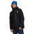 A person wearing a blue beanie and The North Face Men's North Table Down Triclimate Jacket stands with a relaxed posture against a white background.