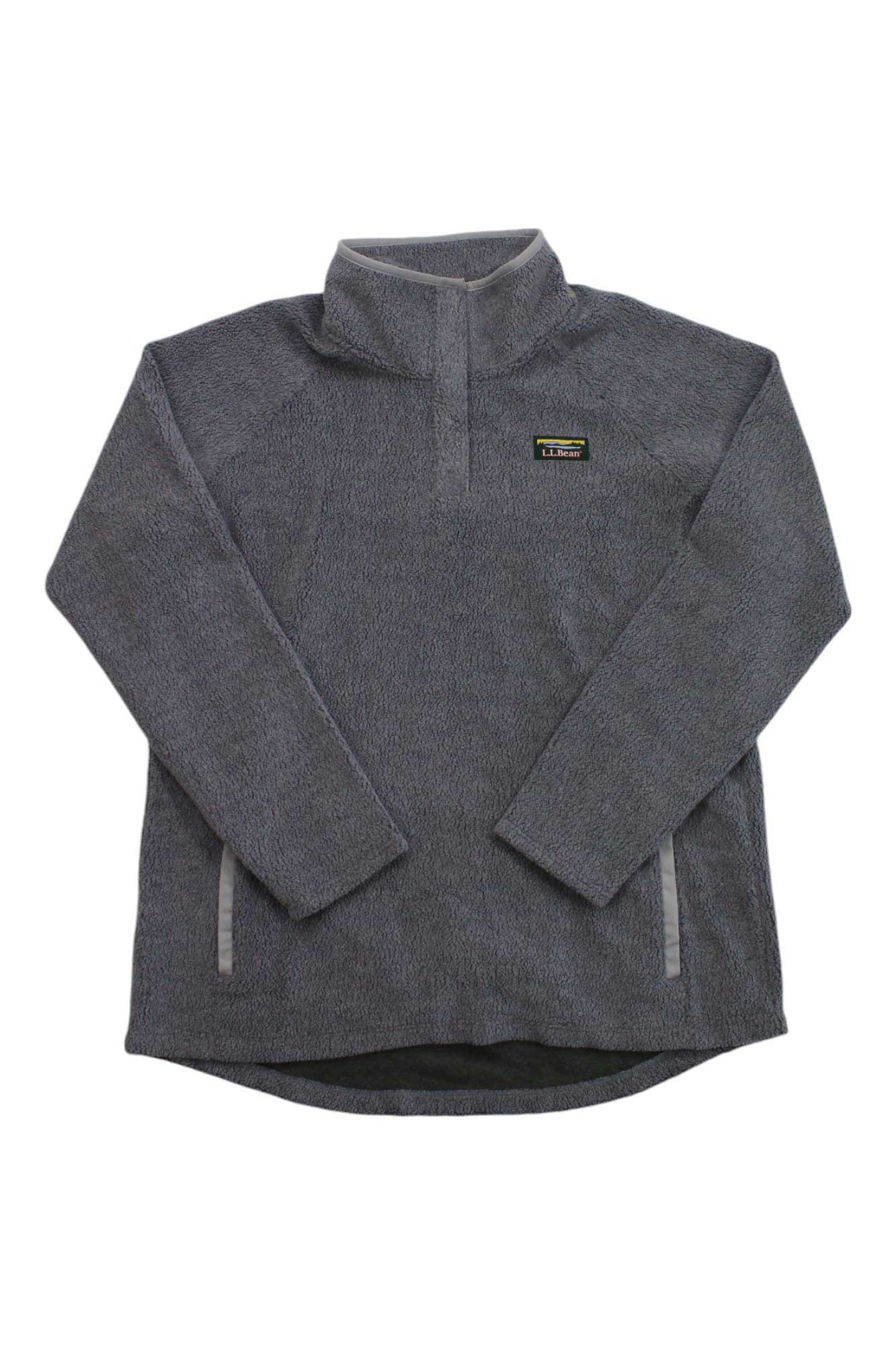 The L.L.Bean Womens Tumbled Sherpa 1/4 Snap Pullover is a gray Sherpa with a quarter-snap collar, two zippered side pockets, and a small logo patch on the left chest for cozy comfort and classic style.