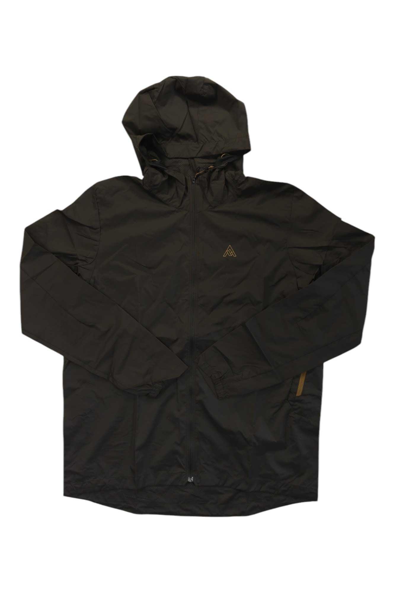 The 7mesh Mens Northwoods Windshell Jacket in black features a front zipper, long sleeves, and a small chest logo—ideal for trail riding. Shown on a white background.