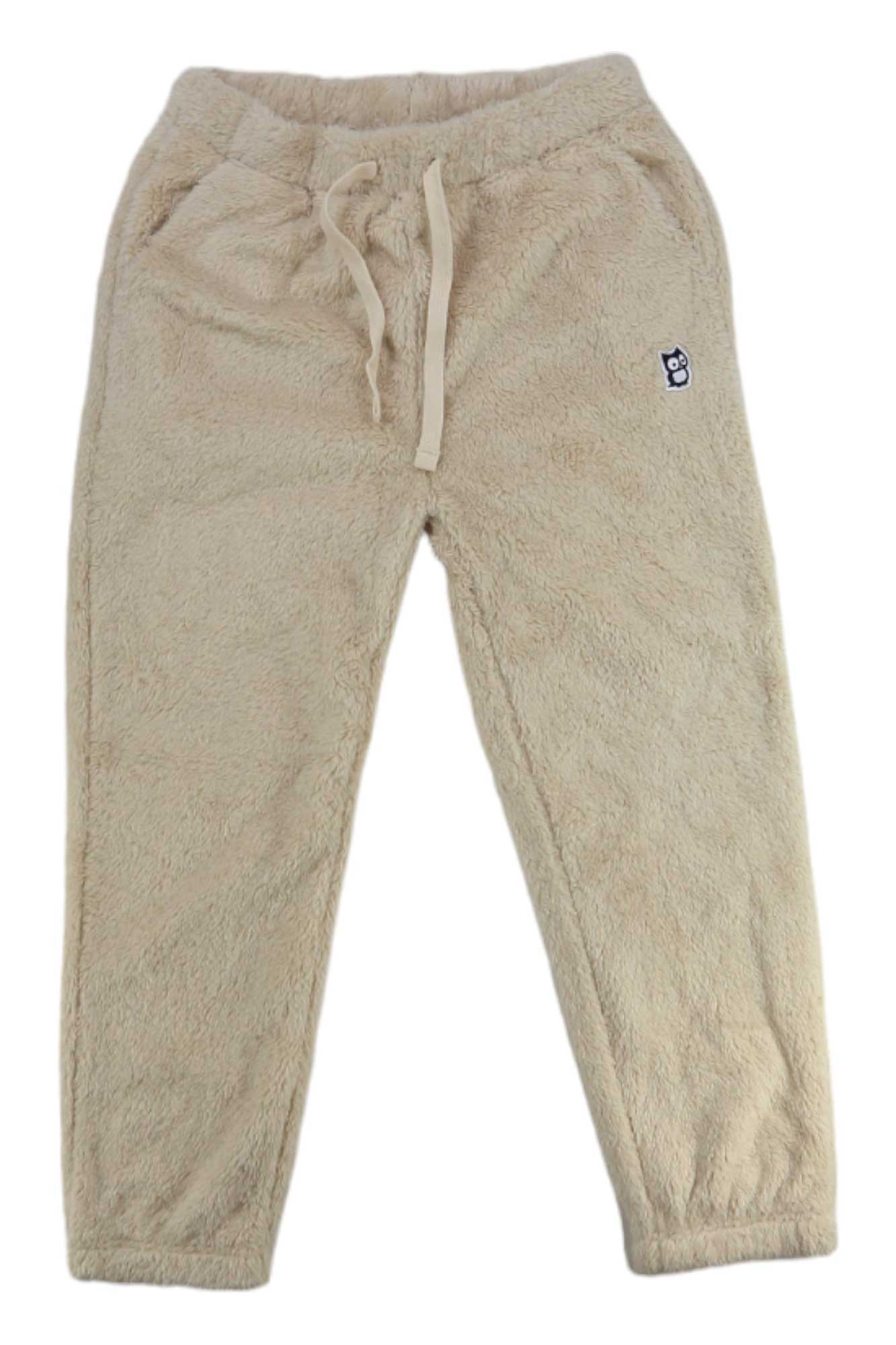 The Namuk Kids' Mine High Loft Fleece Pant features a beige color, elastic waistband with drawstring, side pockets, and a small embroidered logo on the left thigh—ideal casual pants for everyday comfort, shown on a white background.