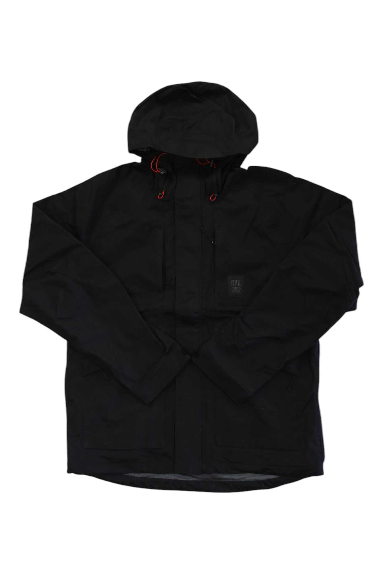 The Topo Designs Mens Mountain Parka is a black, hooded hiking jacket with long sleeves, front zipper and buttons, two front pockets, and red hood drawstrings. This stylish waterproof parka is shown on a white background.