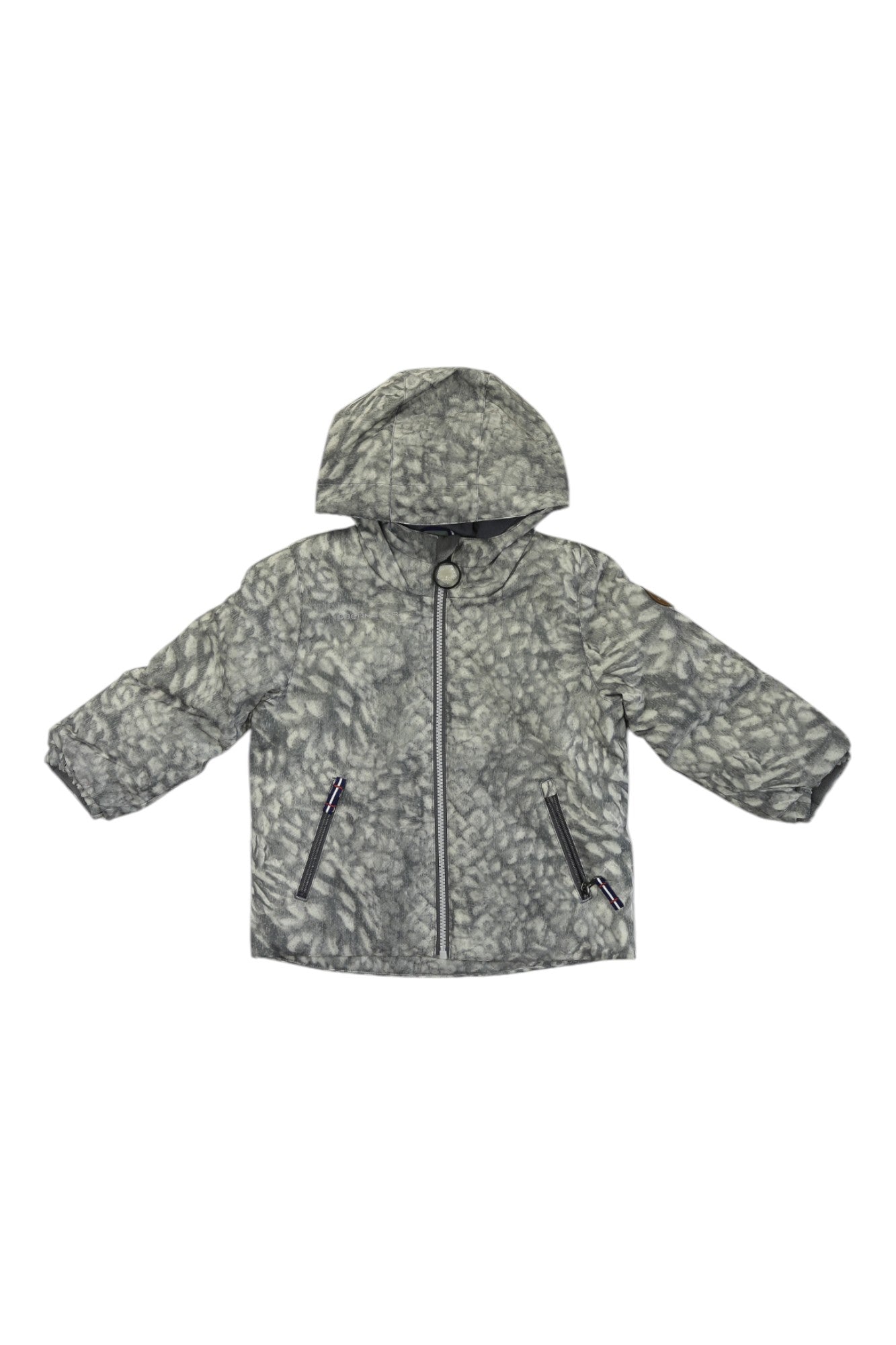 The Obermeyer Kids Ash Jacket is a gray, water-resistant outdoor jacket with a subtle leaf pattern, front zipper, two side zippered pockets, long sleeves, and a relaxed fit—perfect for kids.