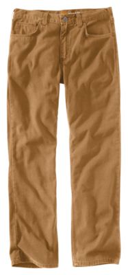 A pair of Carhartt Men's Rugged Flex Rigby Five-Pocket Pants in tan, with a relaxed fit and straight leg, featuring front and back pockets, lies flat on a white background.