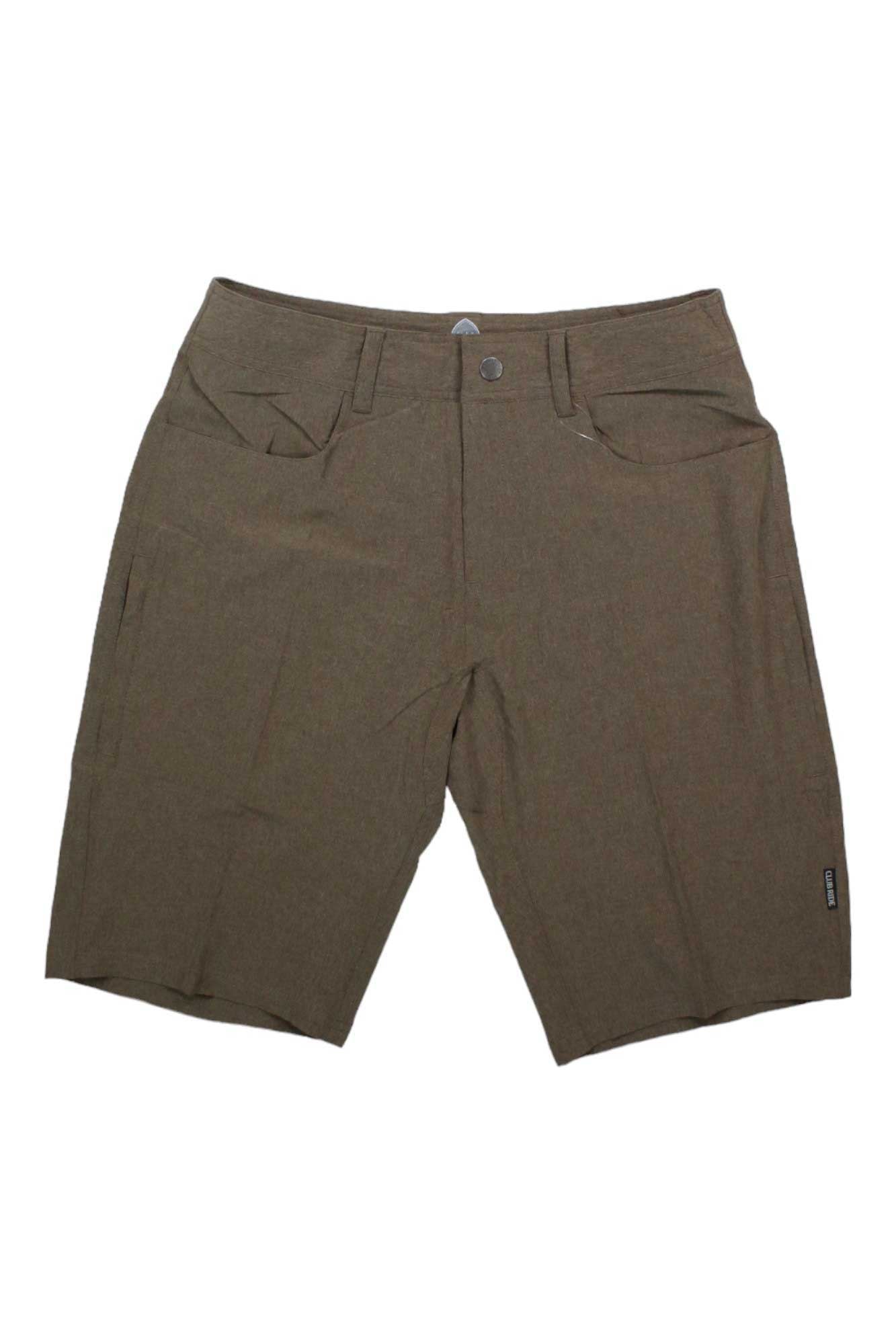 The Club Ride Men's MTN Surf 12 Inch Short is a brown, knee-length option with front pockets, belt loops, and a button closure—perfect for biking and casual wear. Shown against a white background.