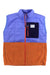 The Cotopaxi Womens Trico Hybrid Vest combines a quilted blue upper, orange fleece lower, navy chest pocket with logo patch, and red zipper. Made from recycled materials with synthetic insulation, it provides warmth and features a high collar.