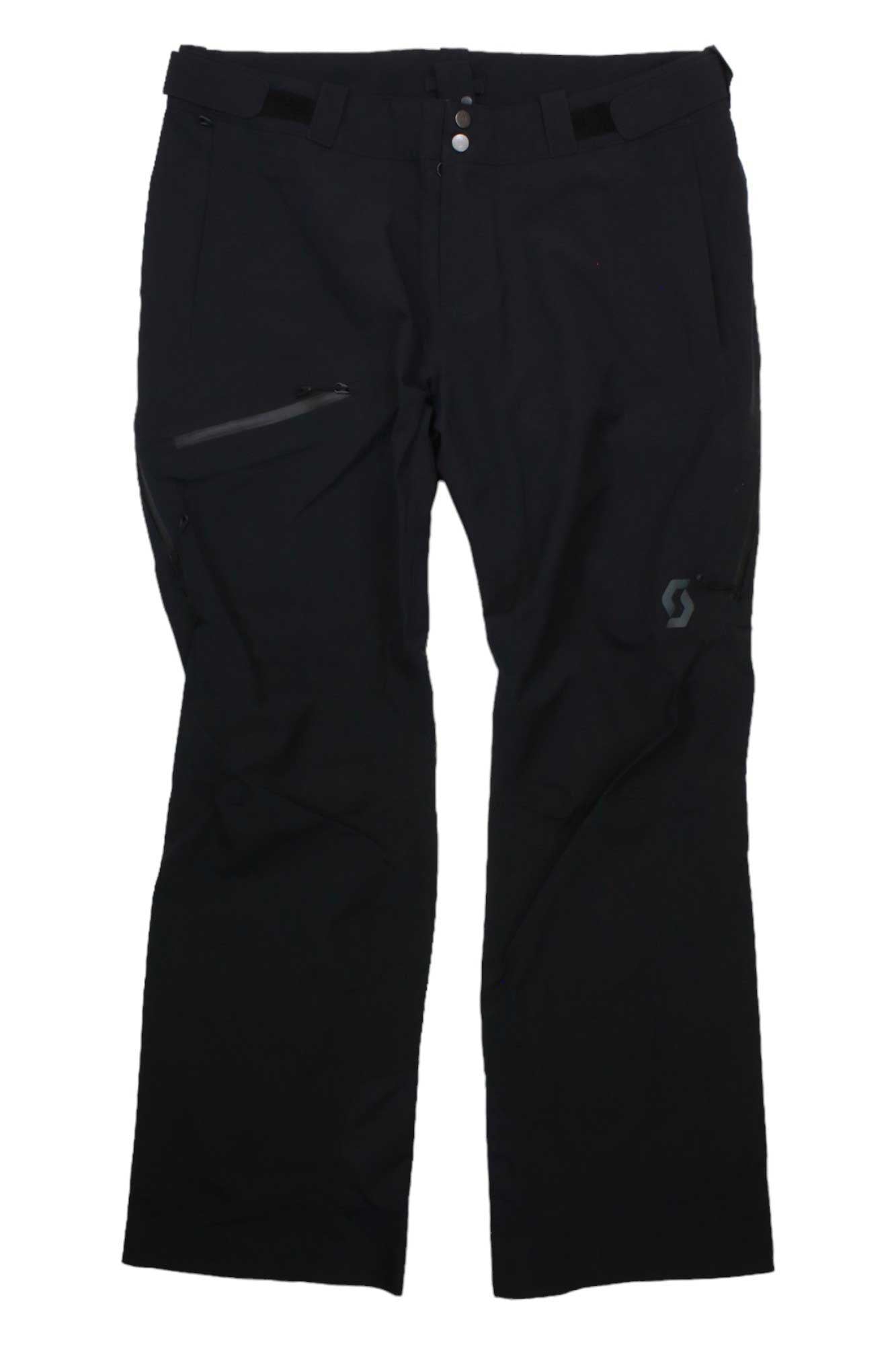 The Scott USA Mens Explorair 3 Layer Pant, black ski shell pants with articulated knees, a zippered side pocket, button and zip closure, and subtle logo on the left thigh, is shown laid flat on a white background.