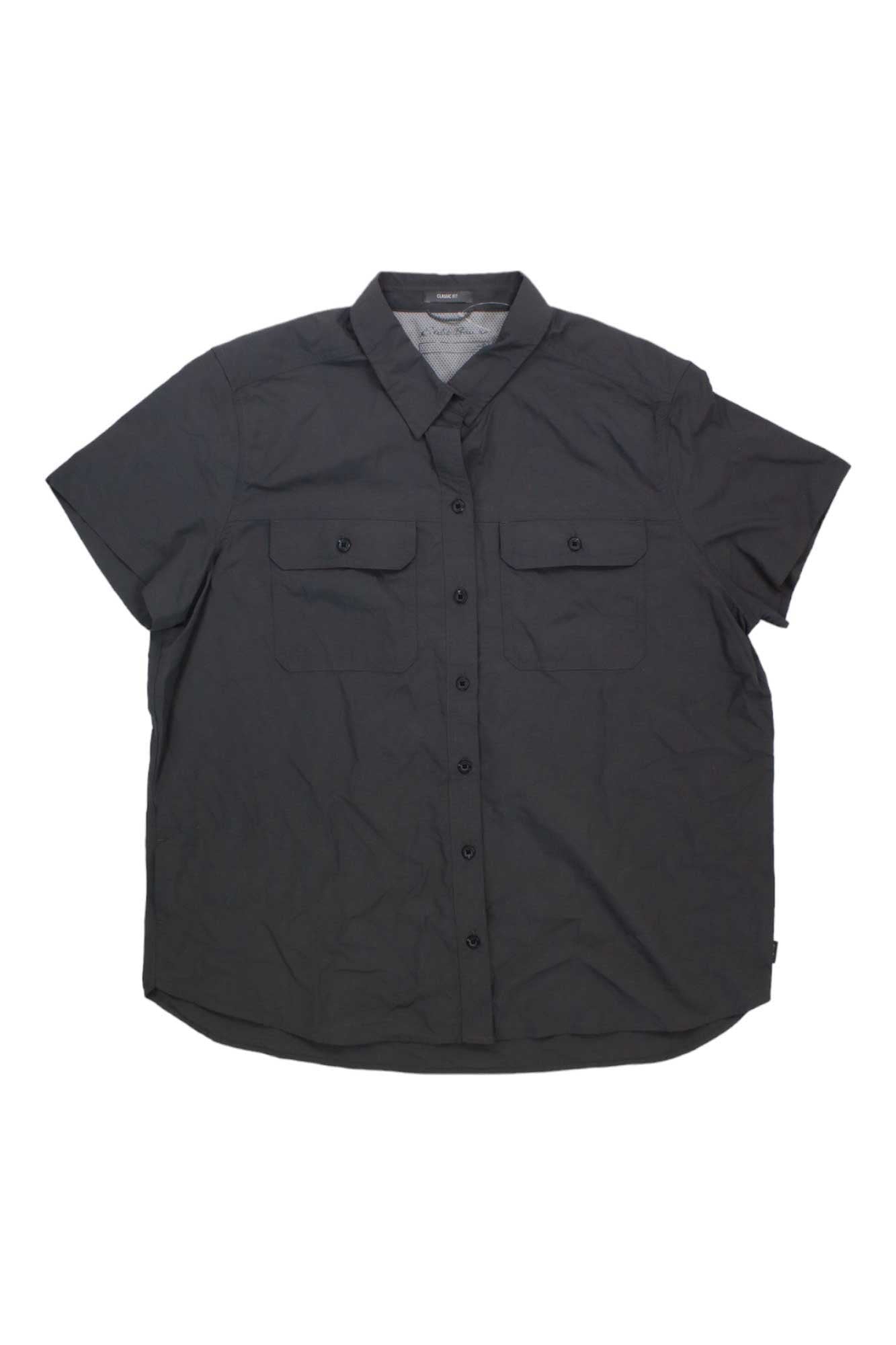 The Eddie Bauer Travex Womens Mountain 2.0 SS Shirt is a short-sleeve, button-up black shirt with two front chest pockets, a collar, moisture-wicking and UV protection, shown on a plain white background.